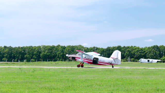 A small airplane lands on the runway.