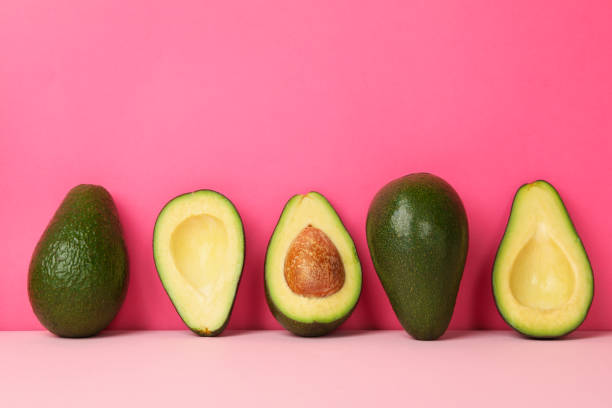 istock Ripe fresh avocado on pink background, space for text 1249570354