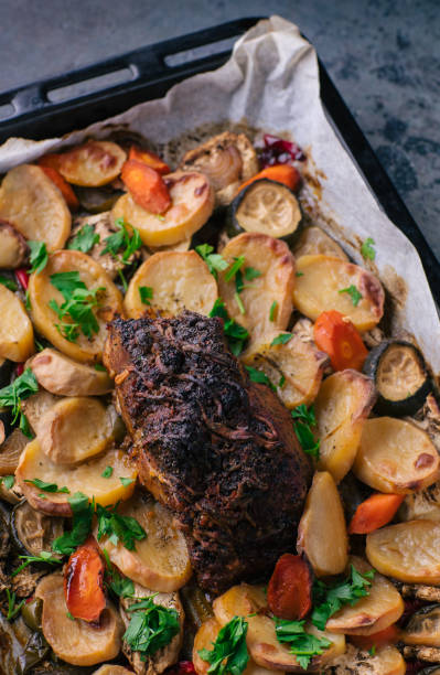 istock Roasted shoulder of pork with potatoes and vegetables 1249571762