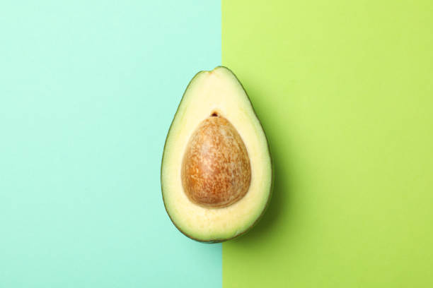 istock Ripe fresh avocado on two tone background, top view 1249571883