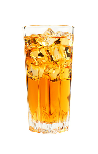 Close up one full high glass of cold iced black tea with transparent ice cubes, isolated on white background, low angle side view