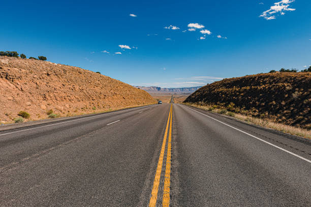 Clear blue sky over Arches Road at Utah National Park, USA Clear blue sky over Arches Road at Utah National Park, USA,Nikon D3x single yellow line sunlight usa utah stock pictures, royalty-free photos & images