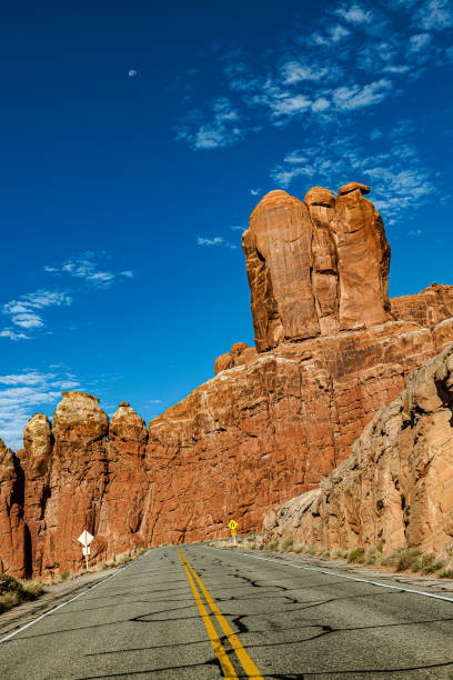 Clear blue sky over Arches Road at Utah National Park, USA Clear blue sky over Arches Road at Utah National Park, USA,Nikon D3x single yellow line sunlight usa utah stock pictures, royalty-free photos & images