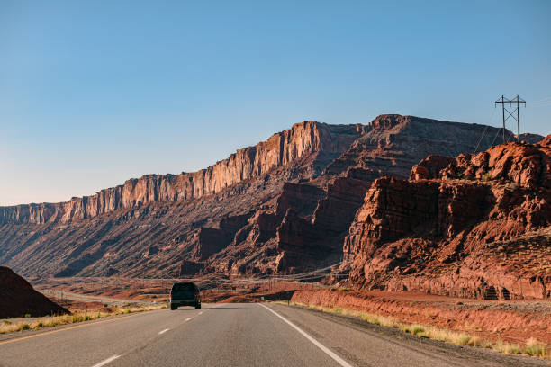Clear blue sky over Arches Road at Utah National Park, USA Clear blue sky over Arches Road at Utah National Park, USA,Nikon D3x single yellow line sunlight usa utah stock pictures, royalty-free photos & images