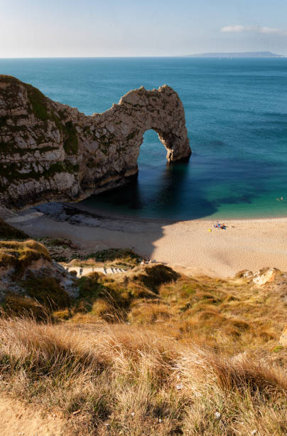 Durdle Door On Dorset's Jurassic Coast The spectacular arch that is Durdle Door, on Dorset's Jurassic Coast. jurassic coast world heritage site stock pictures, royalty-free photos & images