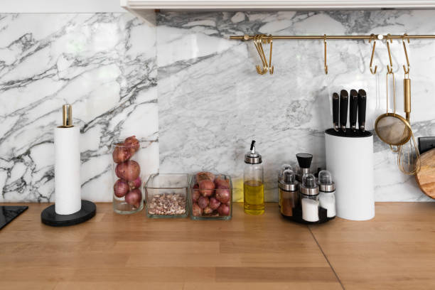 istock Modern classic kitchen interior with kitchen appliances and raw ingredients on wood top with marble wall in the background / kitchen interior 1249577341