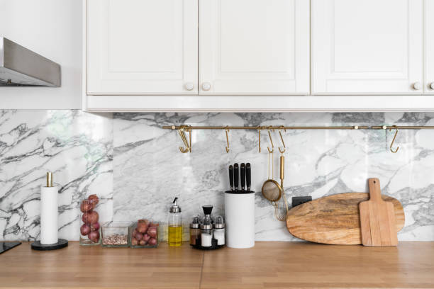 istock Modern classic kitchen interior with kitchen appliances and raw ingredients on wood top with marble wall in the background / kitchen interior 1249577343