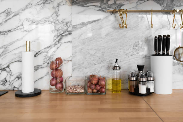 istock Modern classic kitchen interior with kitchen appliances and raw ingredients on wood top with marble wall in the background / kitchen interior 1249577345
