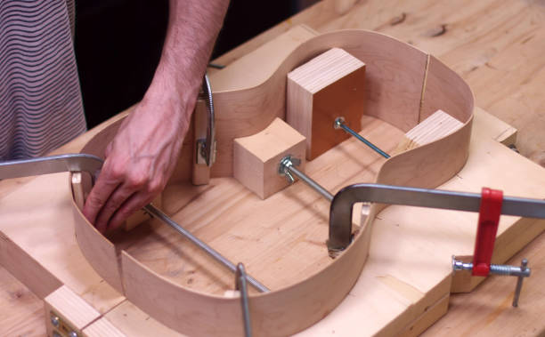 istock instrument maker constructs an acoustic guitar in his store 1249577692