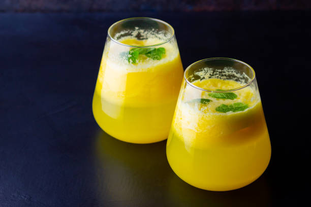 istock Pineapple cocktail on a dark background. Cold pineapple cocktail with mint. Summer tropical cocktail on a black background. Healthy drink 1249577716