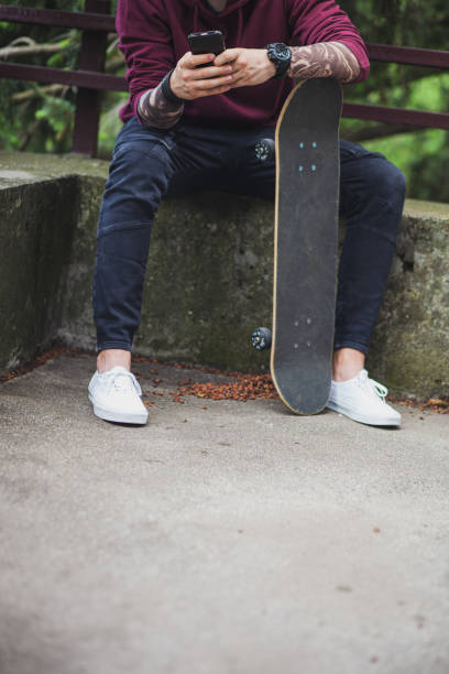 istock Skateboarder enjoying a free time using a phone 1249577875