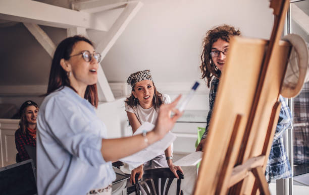 istock Team of young designers  cooperating in the office 1249579706
