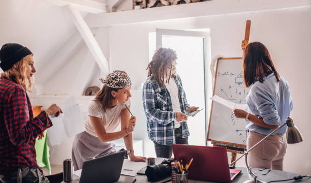 istock Team of young designers  cooperating in the office 1249579752