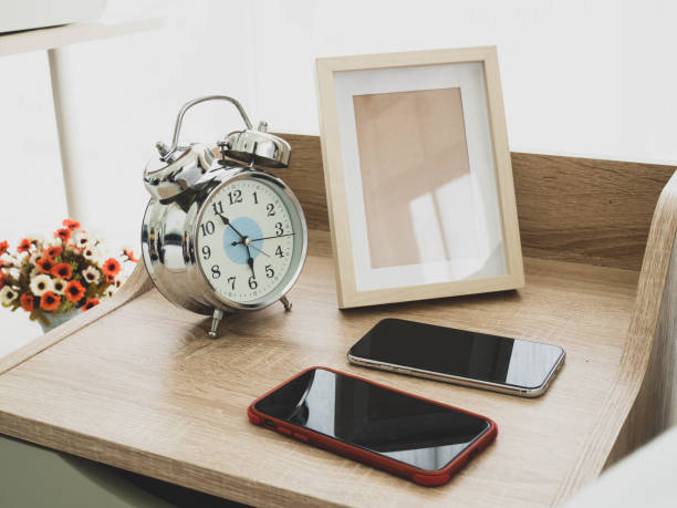 istock Alarm clock and smartphone in the bed room. 1249580667