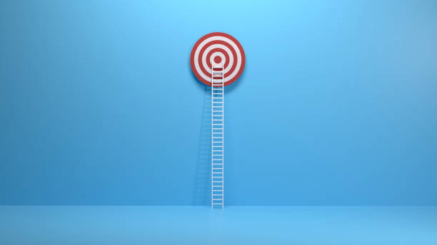 istock White ladder leaning on a red target on blue wall 1249582835