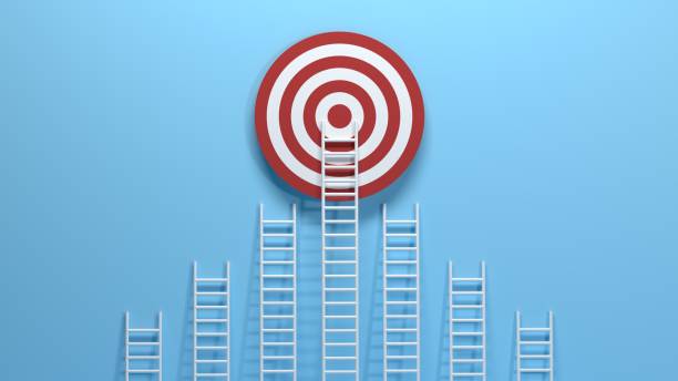 istock White ladder leaning on a red target on blue wall 1249582865