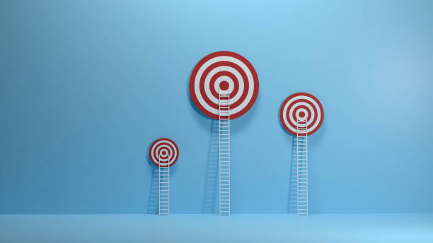 istock White ladder leaning on a red target on blue wall 1249582883