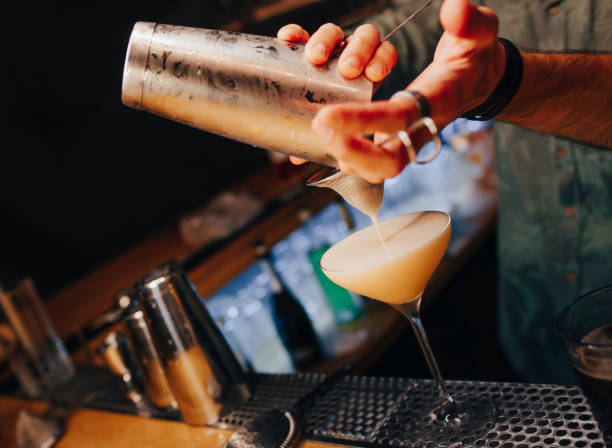 istock Bartender pouring using strainer White healthy Cocktail drink on a bar counter . Professional view . Trendy stylish alcoholic drink .  Design people and luxury concept service barman in nightclub 1249586825