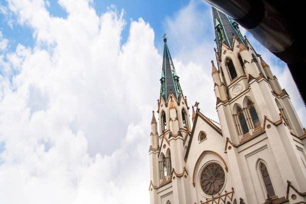With its white facade and its Font for 8 babies to be christened at once and beautiful stained glass these feautures all mark out  the cathedral of St John the Baptist in Savannah Georgia