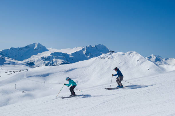 istock Couple skiing in the mountains 1249591245