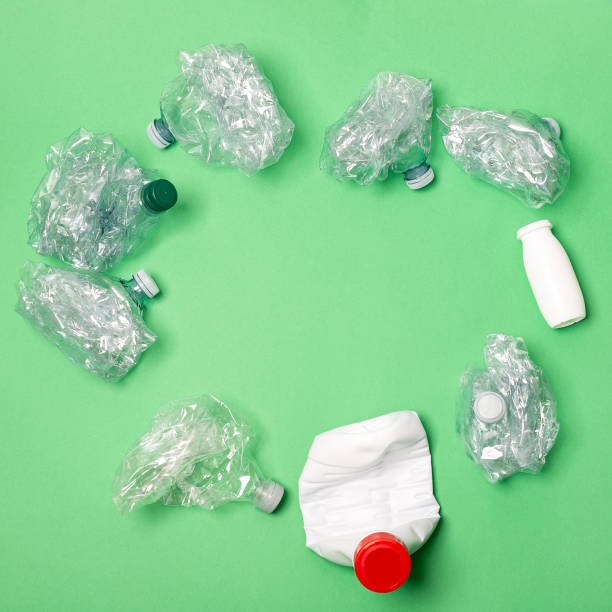 istock Recycled materials on a green background view from above 1249593008