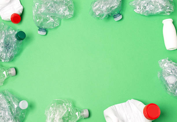 istock Recycled materials on a green background view from above 1249594541