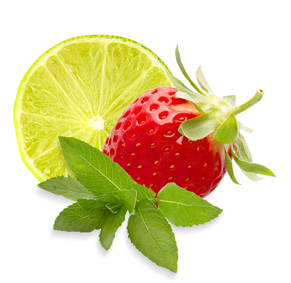 Isolated fruit. Slices mix of lime, strawberry fruits and green mint leaves on white background with clipping path as package design element.