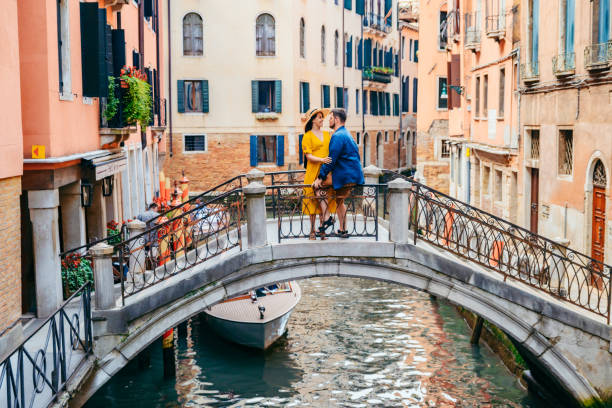 istock couple standing on the bridge crossing venice canals 1249595792