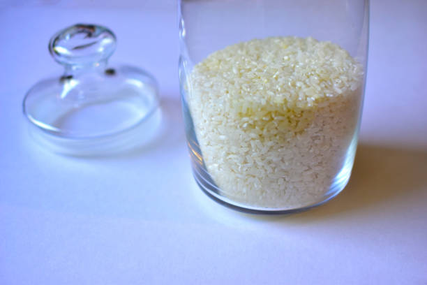istock Glass vessel with a lid and white rice inside 1249596073