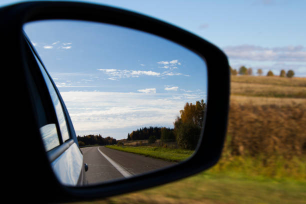 Road in car mirror, nature and objects. stock photo