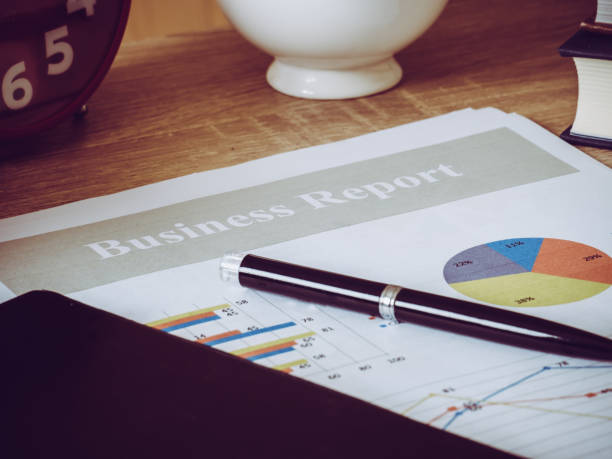 istock Business chart and notebook on wooden table. 1249598974