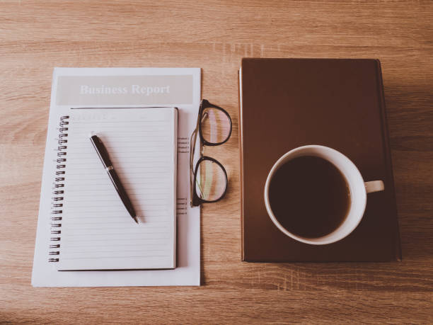 istock Business chart and notebook on wooden table. 1249599060