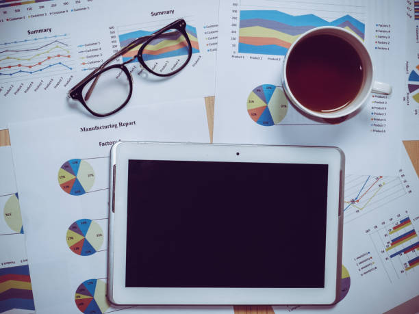 istock Business chart with tablet on wooden table in office. 1249599092