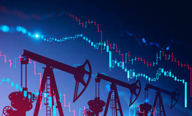 istock Oil pumps and falling graph on blue 1249599741