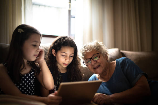 istock Grandmother and granddaughter using digital tablet at home 1249601326
