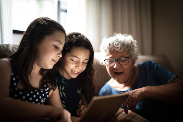 istock Grandmother and granddaughter using digital tablet at home 1249601350