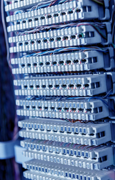 istock Server room. Telephone cables connected to switches. 1249602847