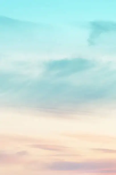 Photo of Vertical ratio size of sunset background. sky with soft and blur pastel colored clouds. gradient cloud on the beach resort. nature. sunrise.  peaceful morning.