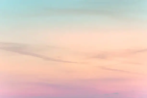Photo of sunset background. sky with soft and blur pastel colored clouds.  gradient cloud on the beach resort. nature. sunrise.  peaceful morning.