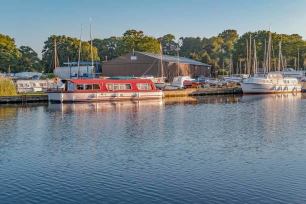istock Boats moored on the River Ant on a summer's evenng 1249609093