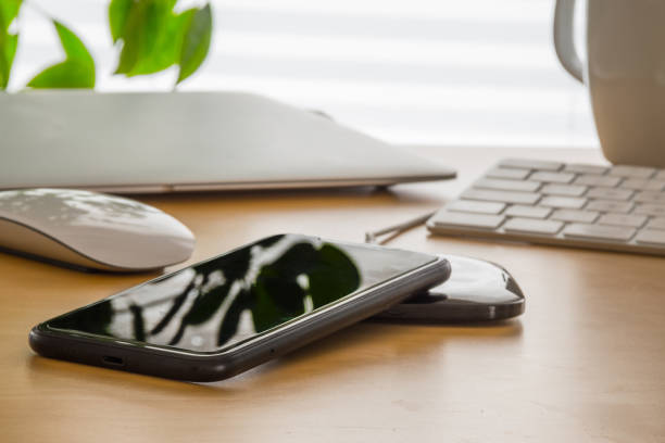 istock Wireless charging of a mobile phone in the home office 1249609775