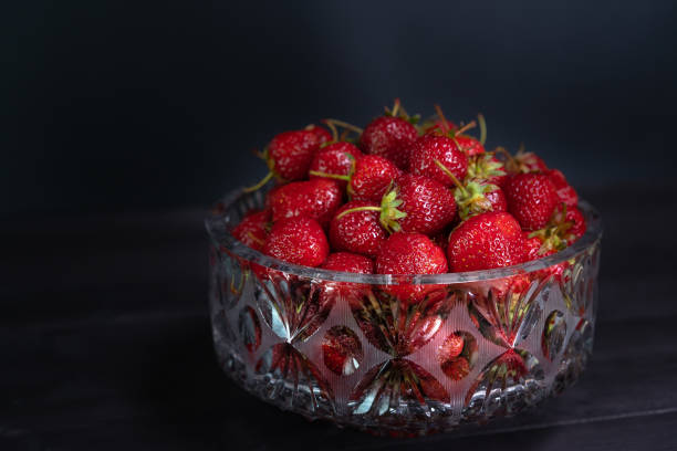 istock Ripe strawberries in a bowl on a background 1249609833