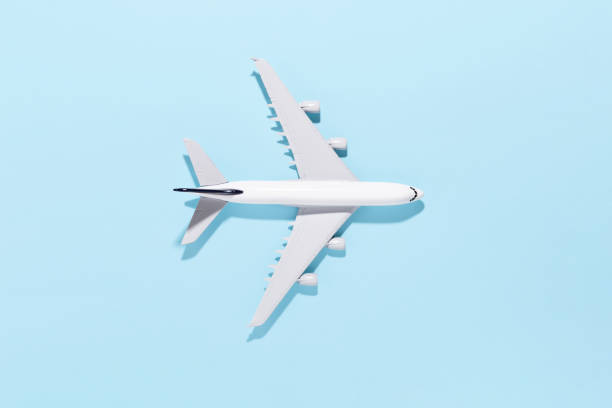 istock Model airplane on light blue color paper background 1249610628