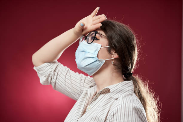 istock Exhausted businesswoman on red background 1249610919