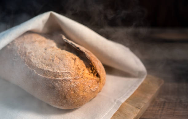 istock Freshly baked bread wrapped in a towel. 1249613097