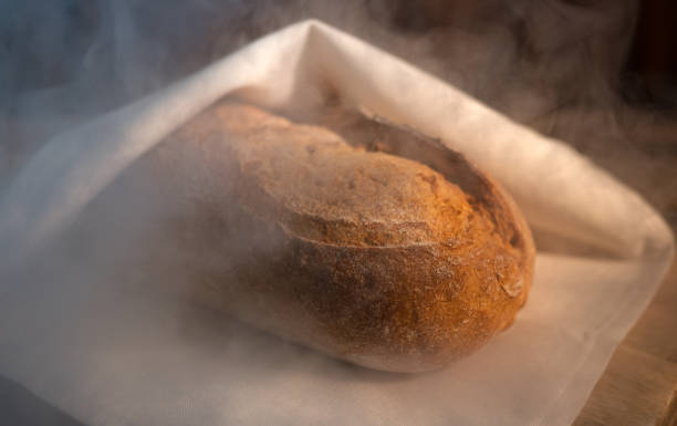 istock Freshly baked bread wrapped in a towel. 1249613103