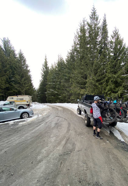 istock Mountain biker prepares to ride by rural road 1249613319