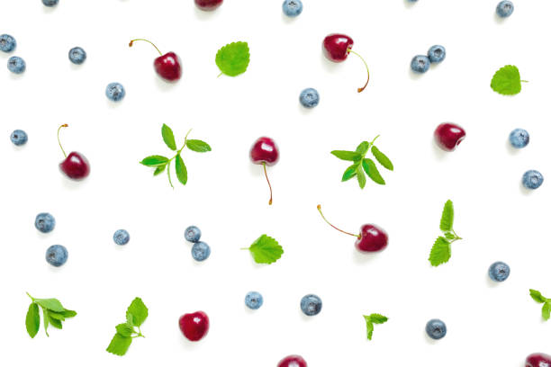 istock Swet cherry and blueberries with mint leaves on white background. Top view. Flat lay summer pattern 1249614046