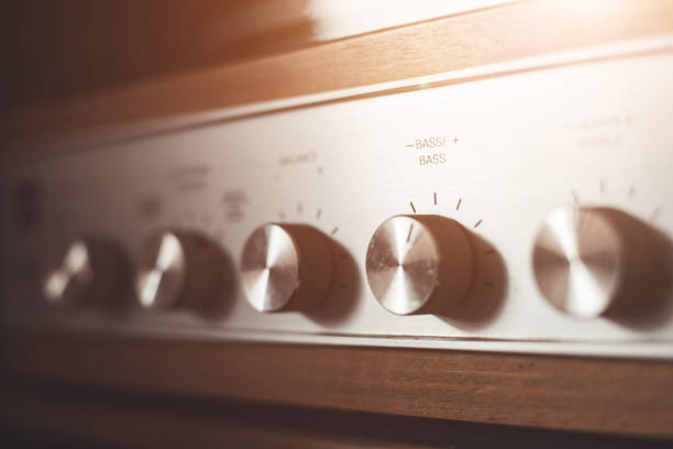 istock Silver wooden vintage amplifier: Close up of control knobs 1249614183