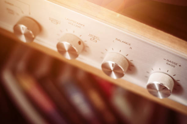Control knops of silver wooden vintage amplifier, closeup